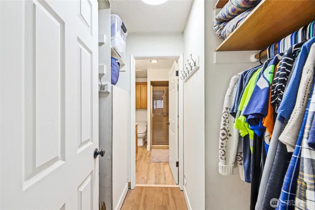 a view of walk in closet with clothes and shoes