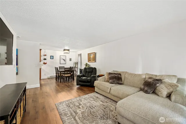 a living room with furniture and wooden floor