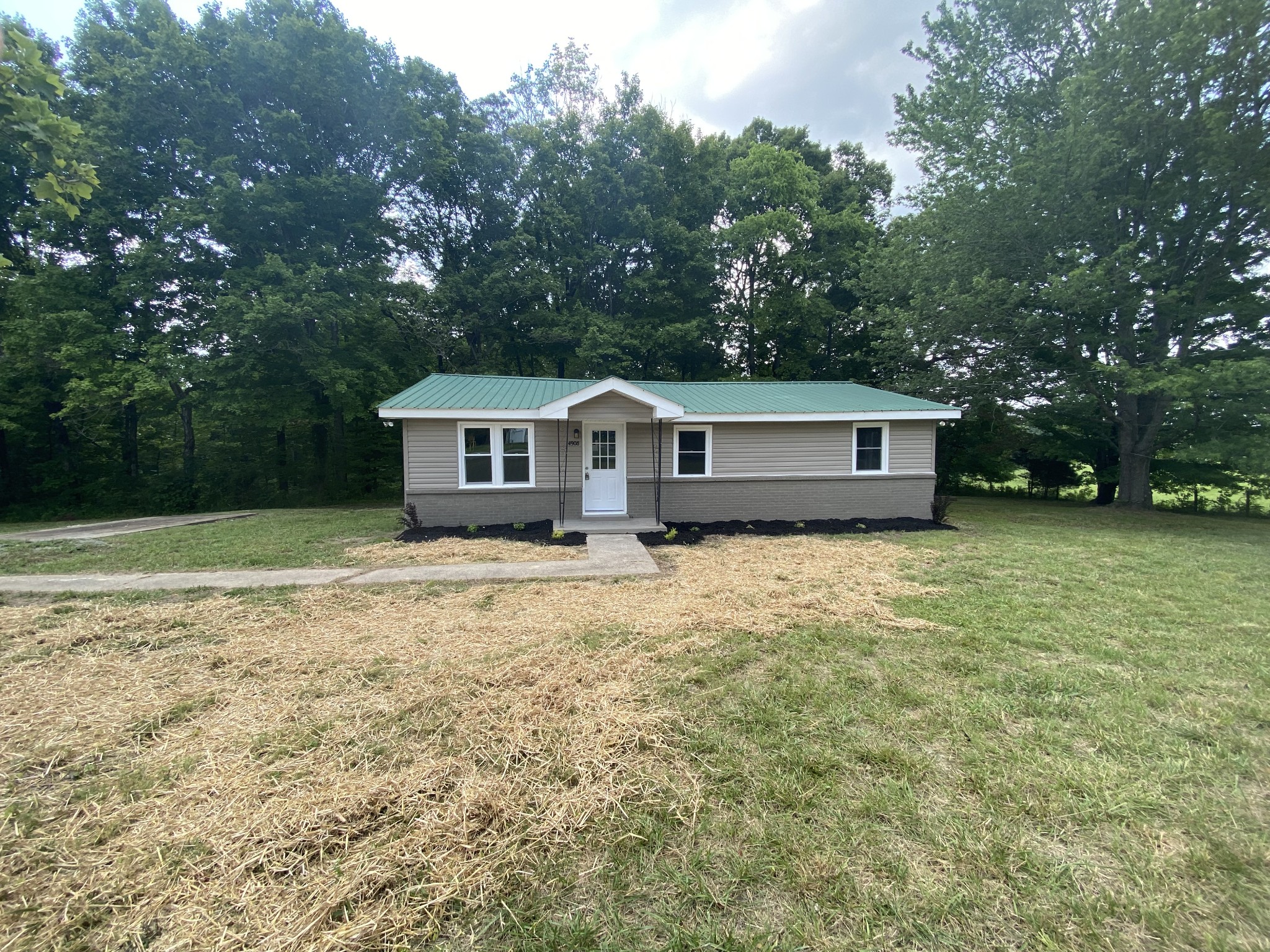 4908 Marion Road Cunningham, TN 37052 - Photo 2 of 27 a house view with a garden space