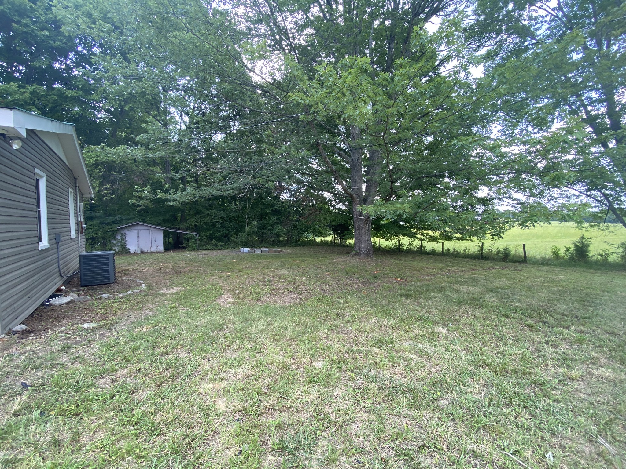 4908 Marion Road Cunningham, TN 37052 - Photo 12 of 27 a backyard of a house with lots of green space