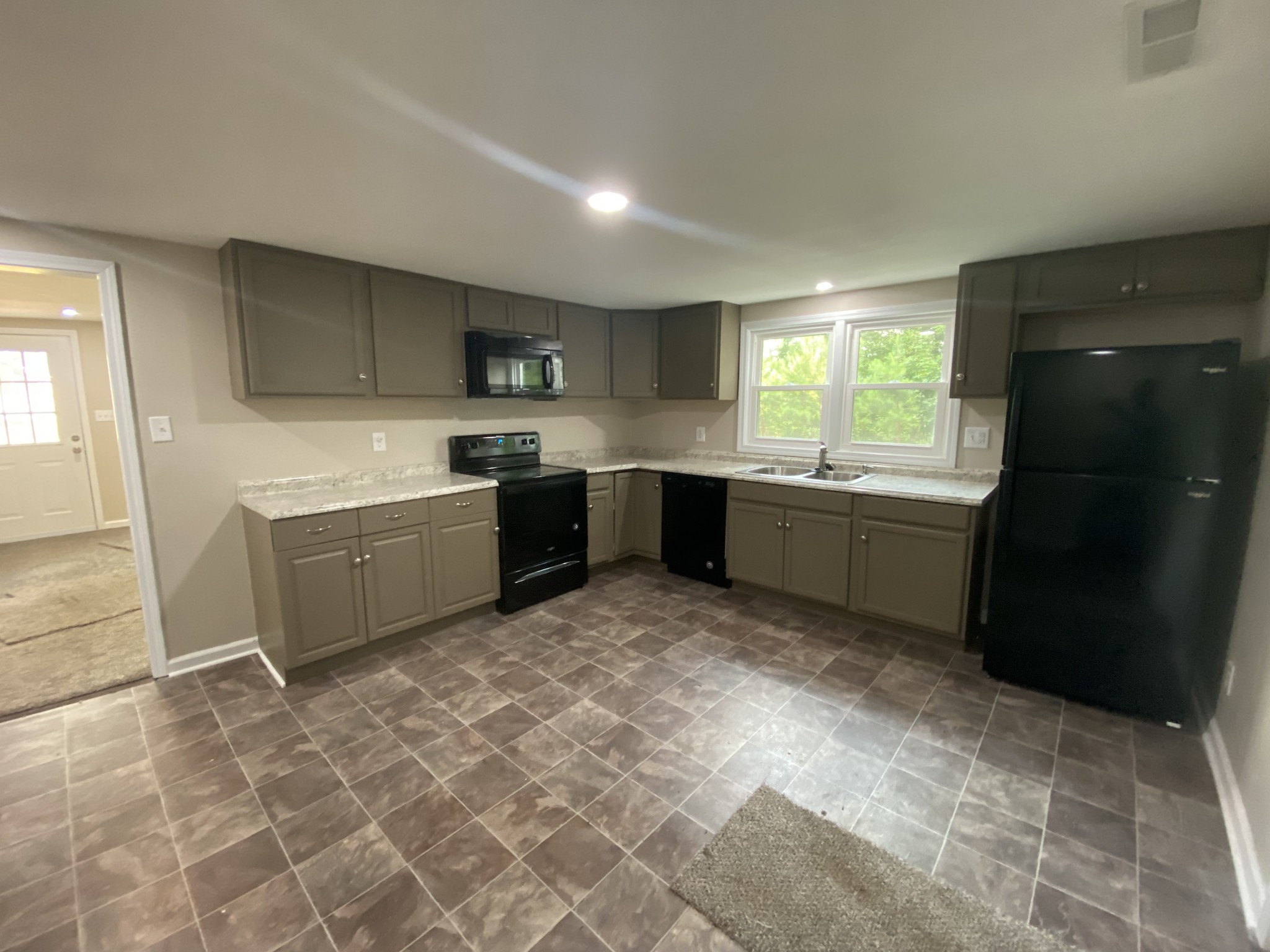 4908 Marion Road Cunningham, TN 37052 - Photo 21 of 27 a kitchen with a sink a stove and cabinets