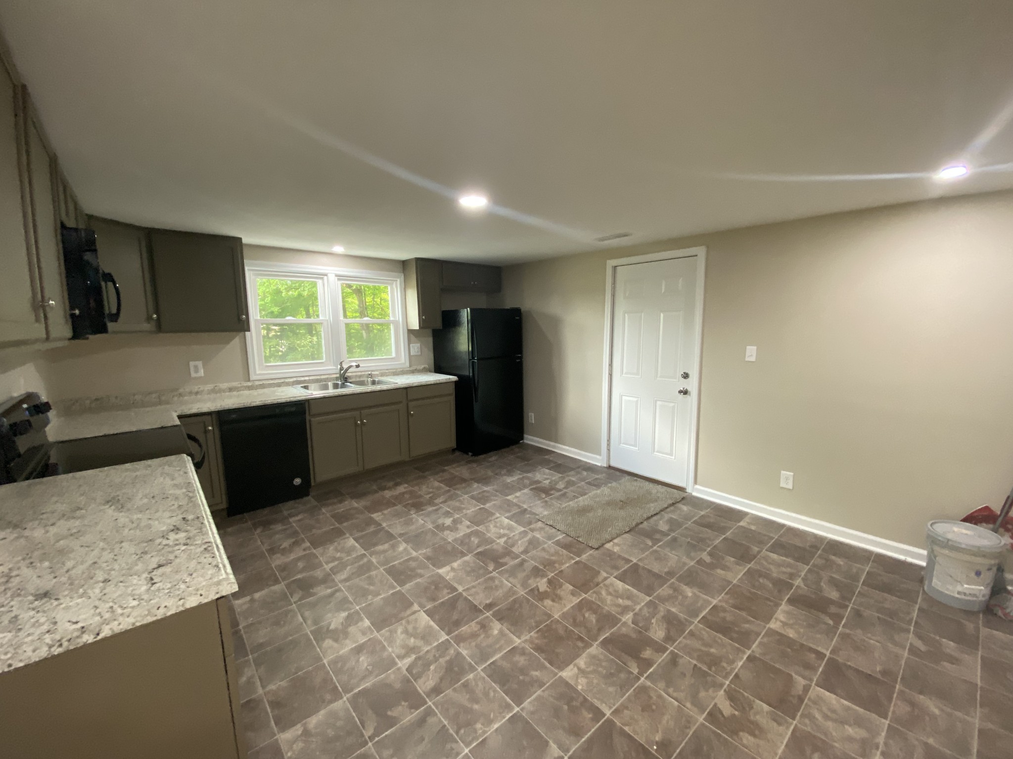 4908 Marion Road Cunningham, TN 37052 - Photo 22 of 27 a kitchen with granite countertop a sink and a stove top oven