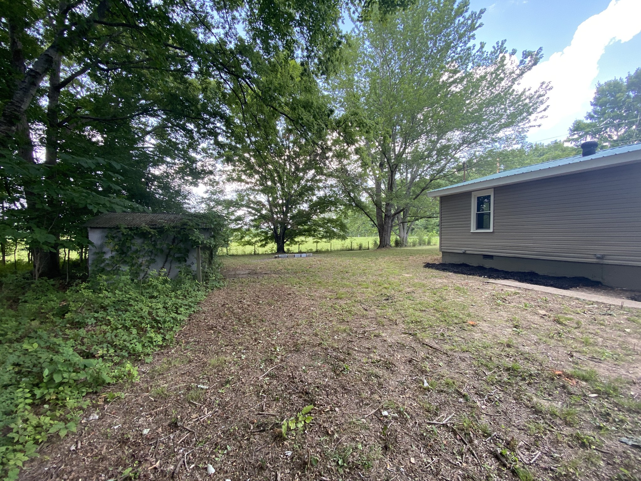 4908 Marion Road Cunningham, TN 37052 - Photo 7 of 27 a backyard of a house with lots of green space