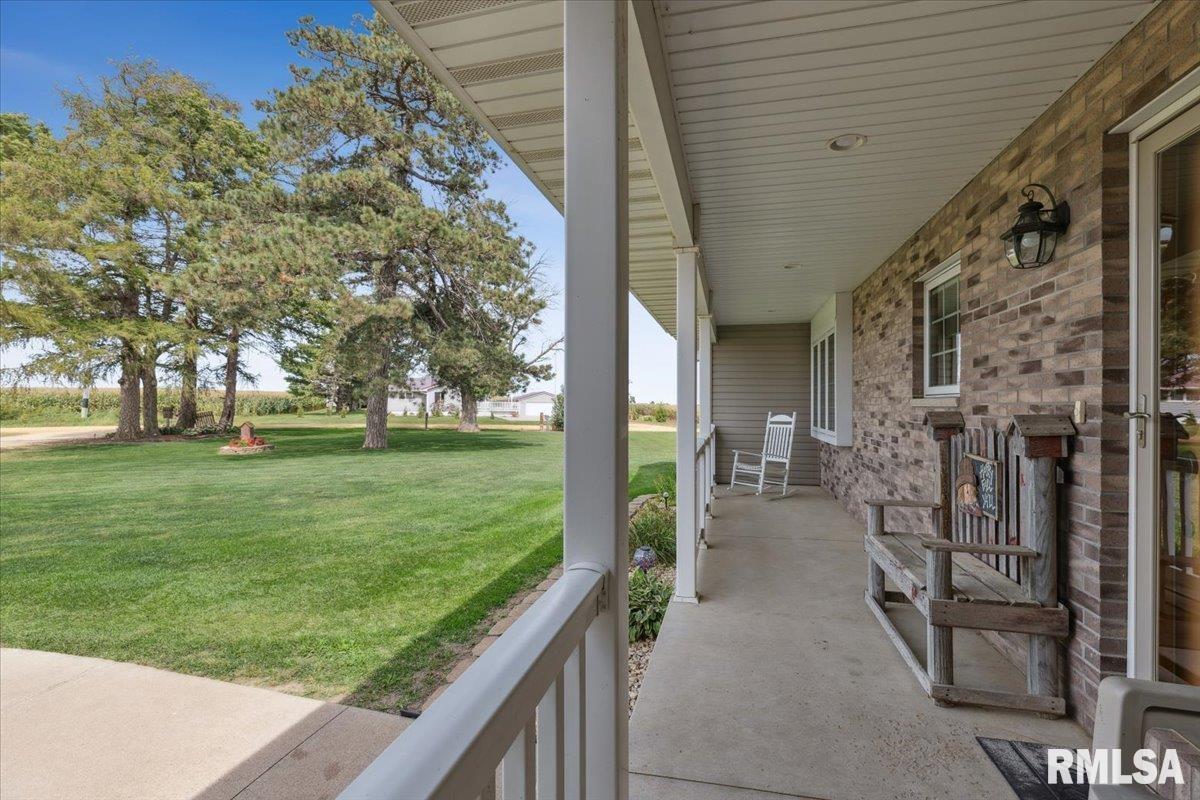 3983 120th Street Bryant, IA 52727 - Photo 12 of 62 a view of a porch with a big yard and large tree
