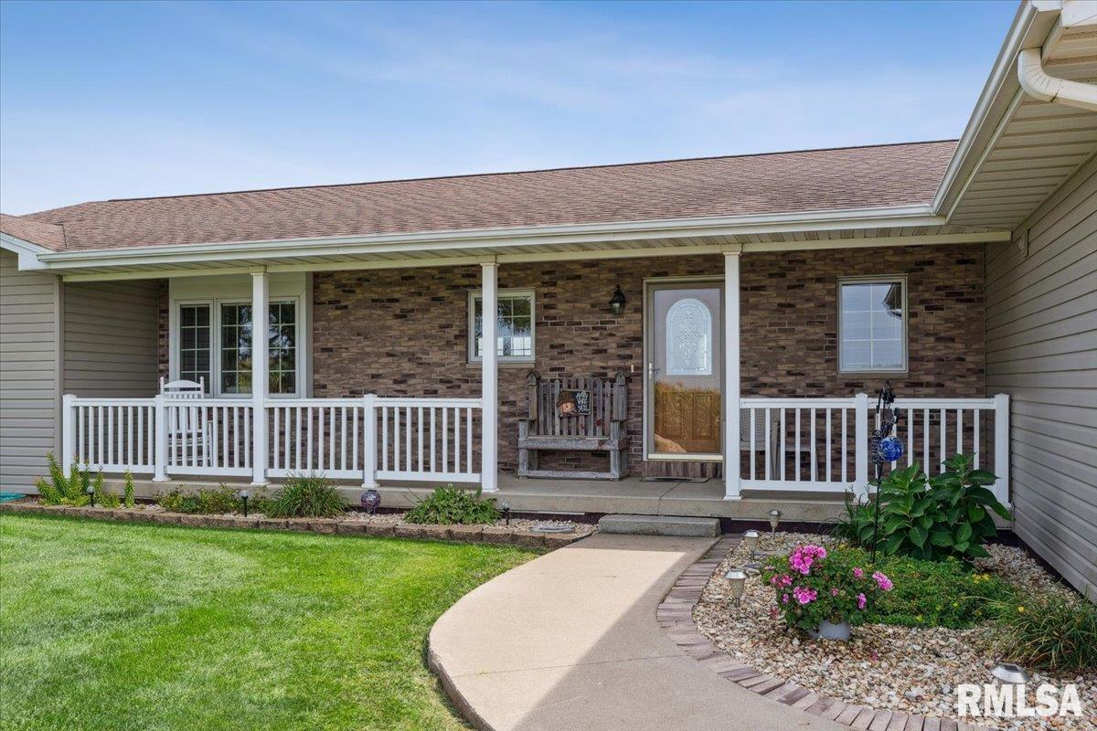 3983 120th Street Bryant, IA 52727 - Photo 13 of 62 a front view of a house with a garden