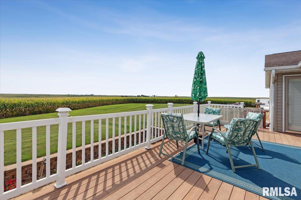 3983 120th Street Bryant, IA 52727 - Photo 17 of 62 a view of a balcony with wooden floor and outdoor seating