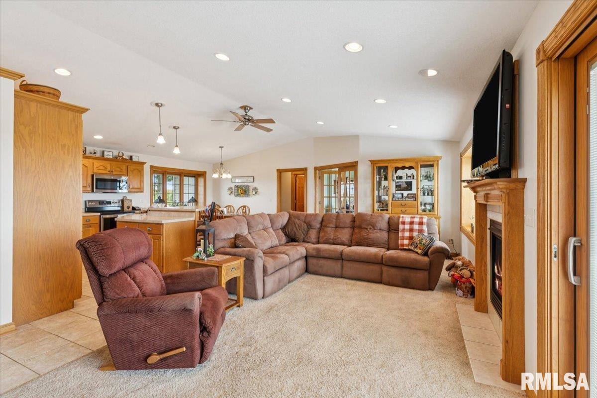 3983 120th Street Bryant, IA 52727 - Photo 20 of 62 a living room with furniture a flat screen tv and a refrigerator