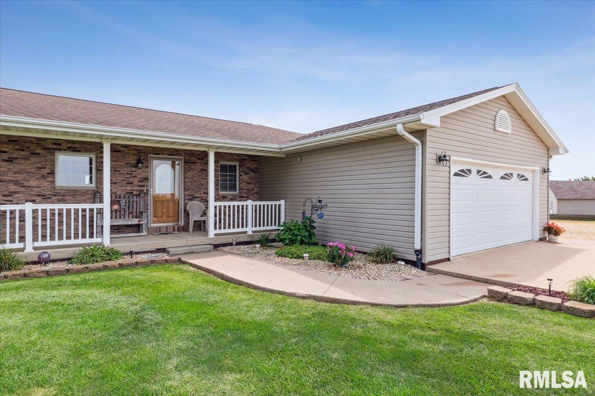 3983 120th Street Bryant, IA 52727 - Photo 2 of 62 a view of a house with a backyard and a porch