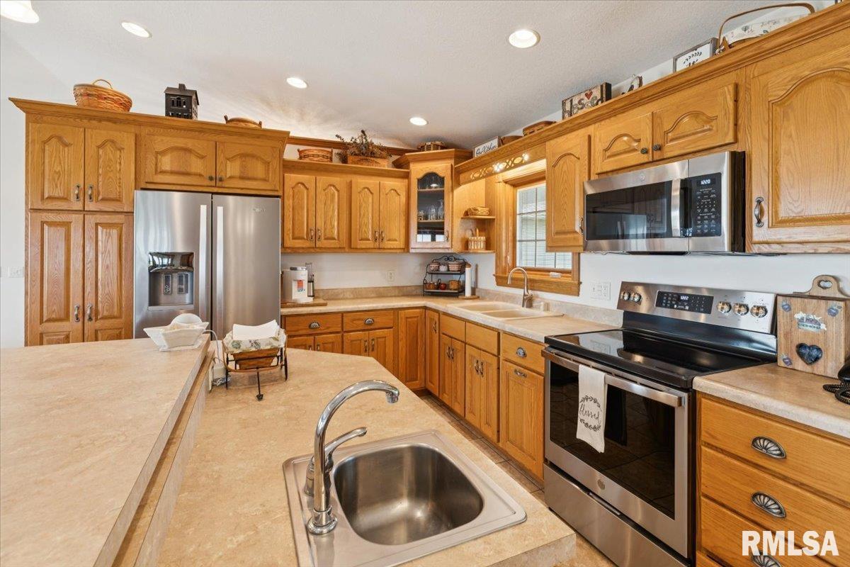 3983 120th Street Bryant, IA 52727 - Photo 24 of 62 a kitchen with a sink a stove and cabinets