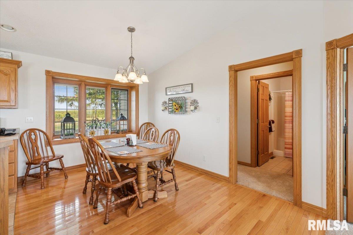 3983 120th Street Bryant, IA 52727 - Photo 26 of 62 a dining room with furniture window wooden floor