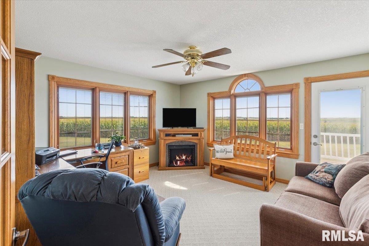 3983 120th Street Bryant, IA 52727 - Photo 27 of 62 a living room with furniture and a fireplace