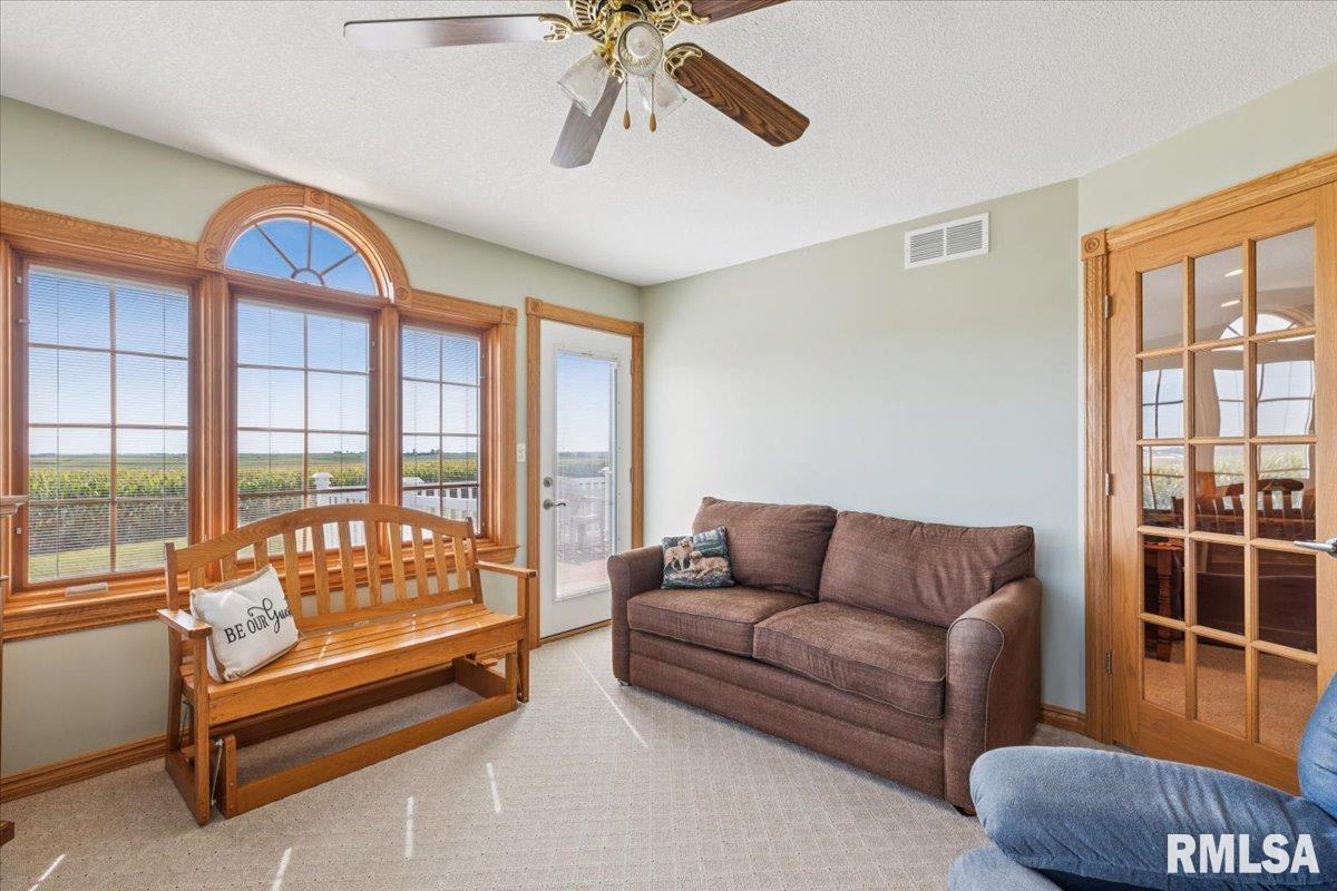 3983 120th Street Bryant, IA 52727 - Photo 28 of 62 a living room with furniture and a large window