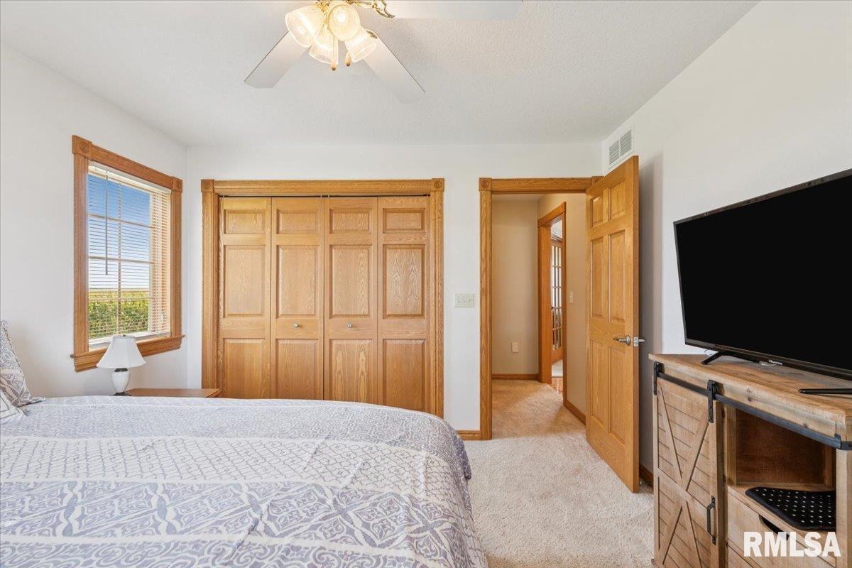 3983 120th Street Bryant, IA 52727 - Photo 30 of 62 a bedroom with a bed and a flat screen tv