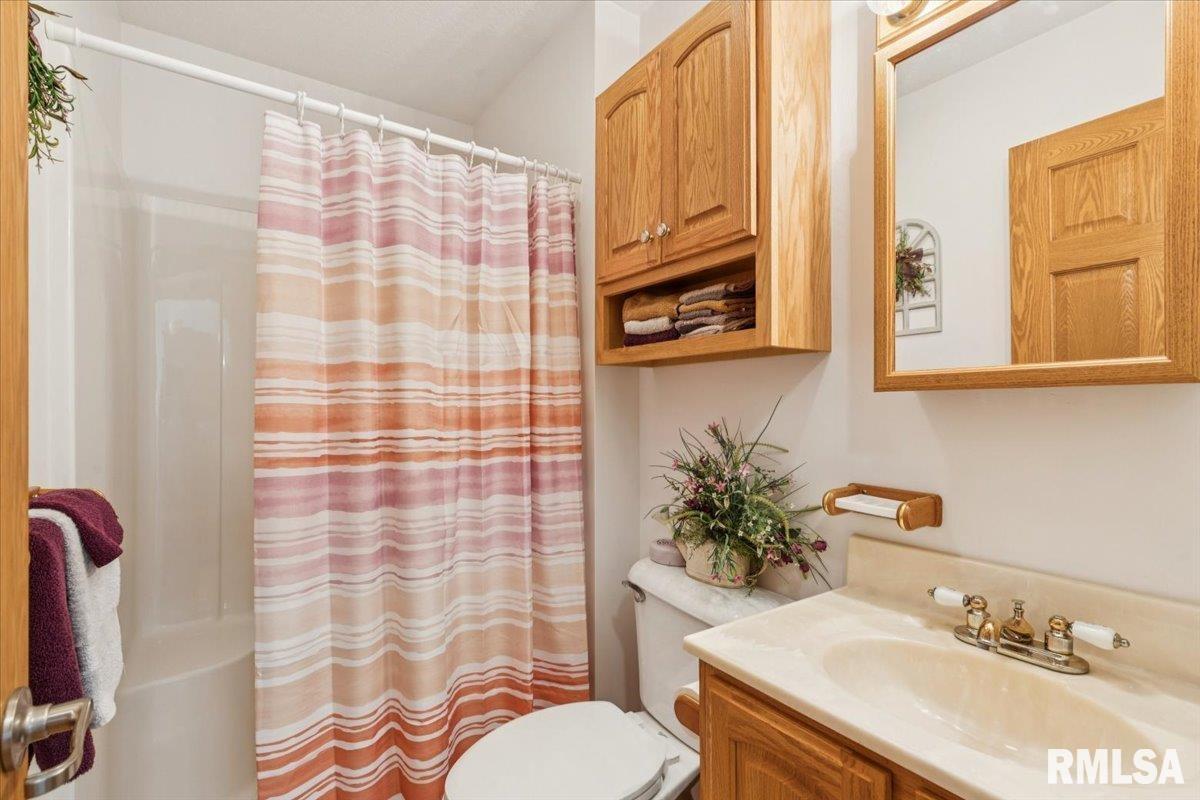 3983 120th Street Bryant, IA 52727 - Photo 31 of 62 a bathroom with a sink toilet and shower