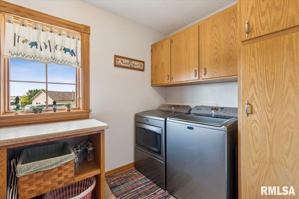 3983 120th Street Bryant, IA 52727 - Photo 39 of 62 a kitchen with stainless steel appliances a stove and a refrigerator