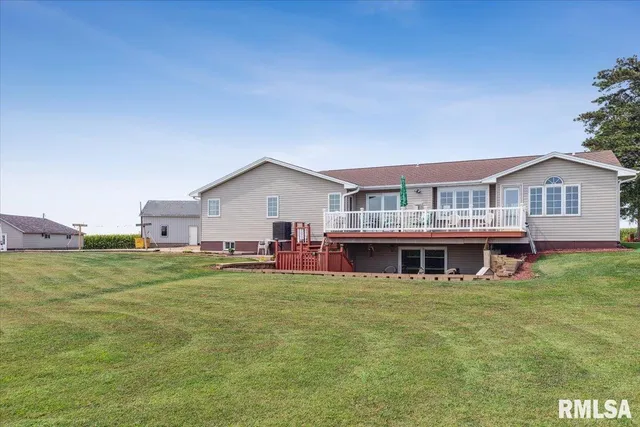 a view of a house with a yard and sitting area