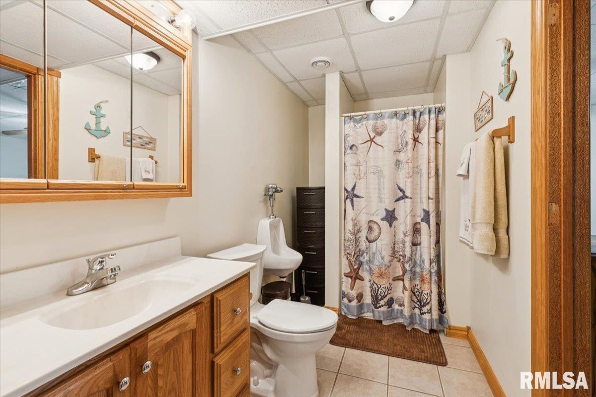 3983 120th Street Bryant, IA 52727 - Photo 49 of 62 a bathroom with a sink toilet and shower