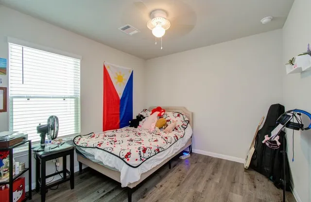 a bedroom with a bed and a window