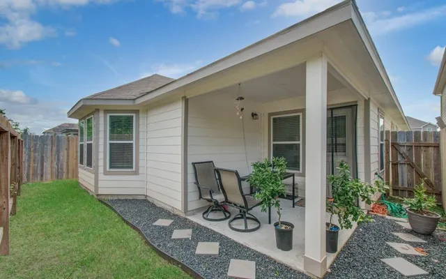 a view of a house with backyard and sitting area