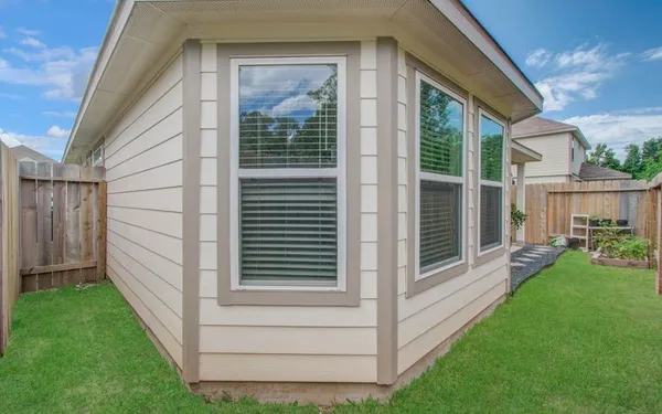 a view of front door and yard from a balcony
