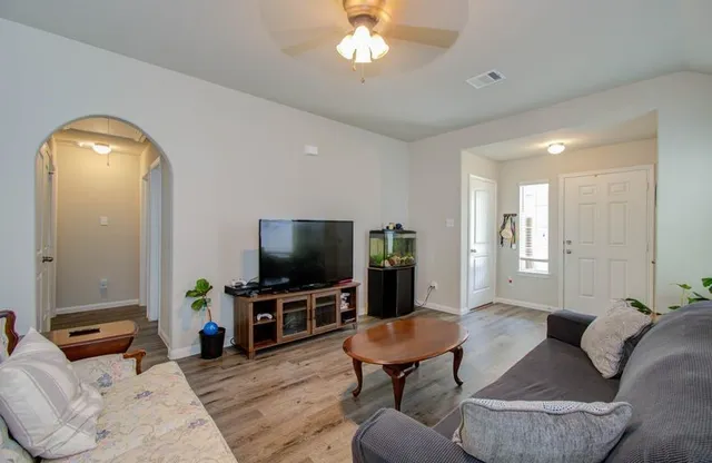 a living room with furniture and a flat screen tv
