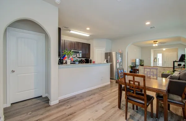 a view of a dining room with furniture and wooden floor
