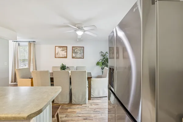 a view of a dining room with furniture and a chandelier