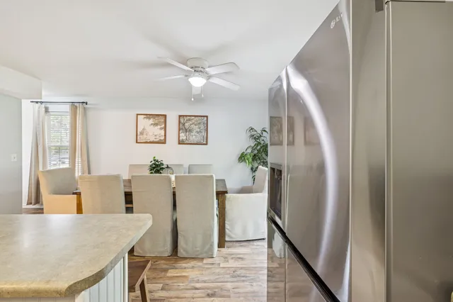 a view of a dining room with furniture and a chandelier