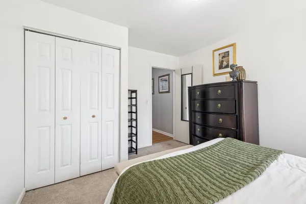 a bedroom with a bed and a closet