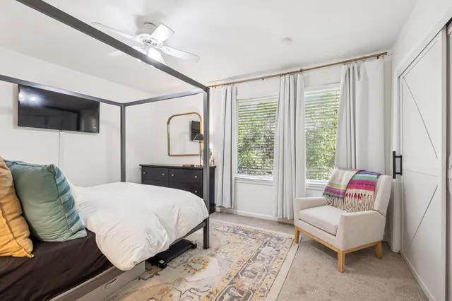 a bedroom with a bed a couch and dresser