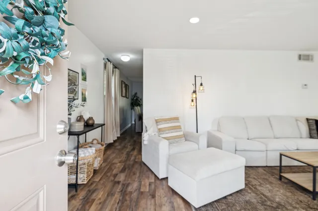 a living room with furniture and wooden floor