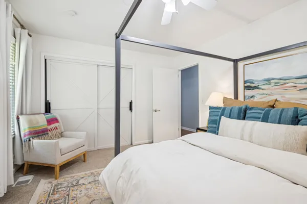 a bedroom with a bed and a couch