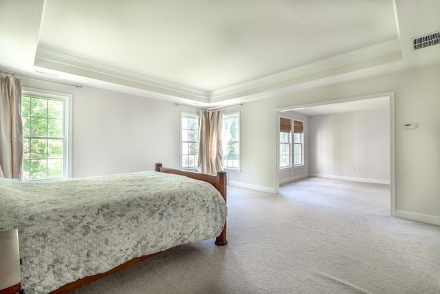 an empty room with a bed and a window