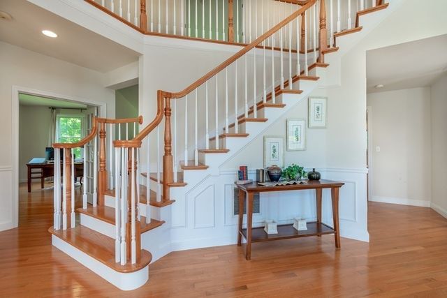 a view of entryway with wooden floor and stairs