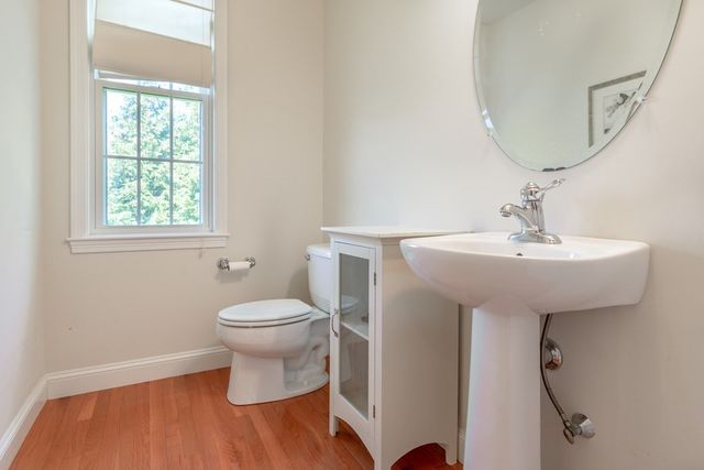 a bathroom with a sink toilet and a mirror