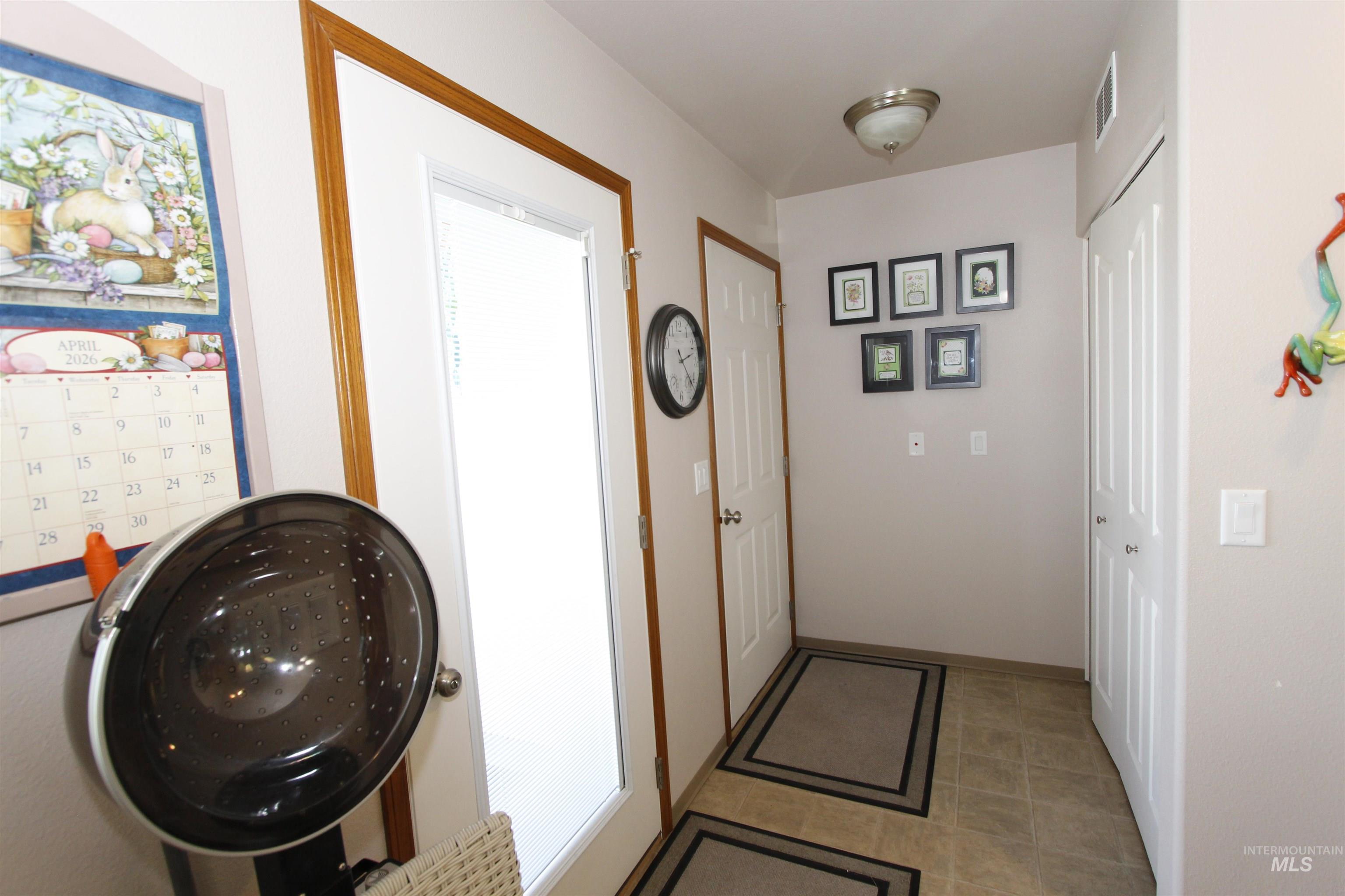 1803 16th Street Lewiston, ID 83501 - Photo 13 of 22 Entryway featuring a white frosted-glass door with wood trim, neutral tone walls, and tile flooring