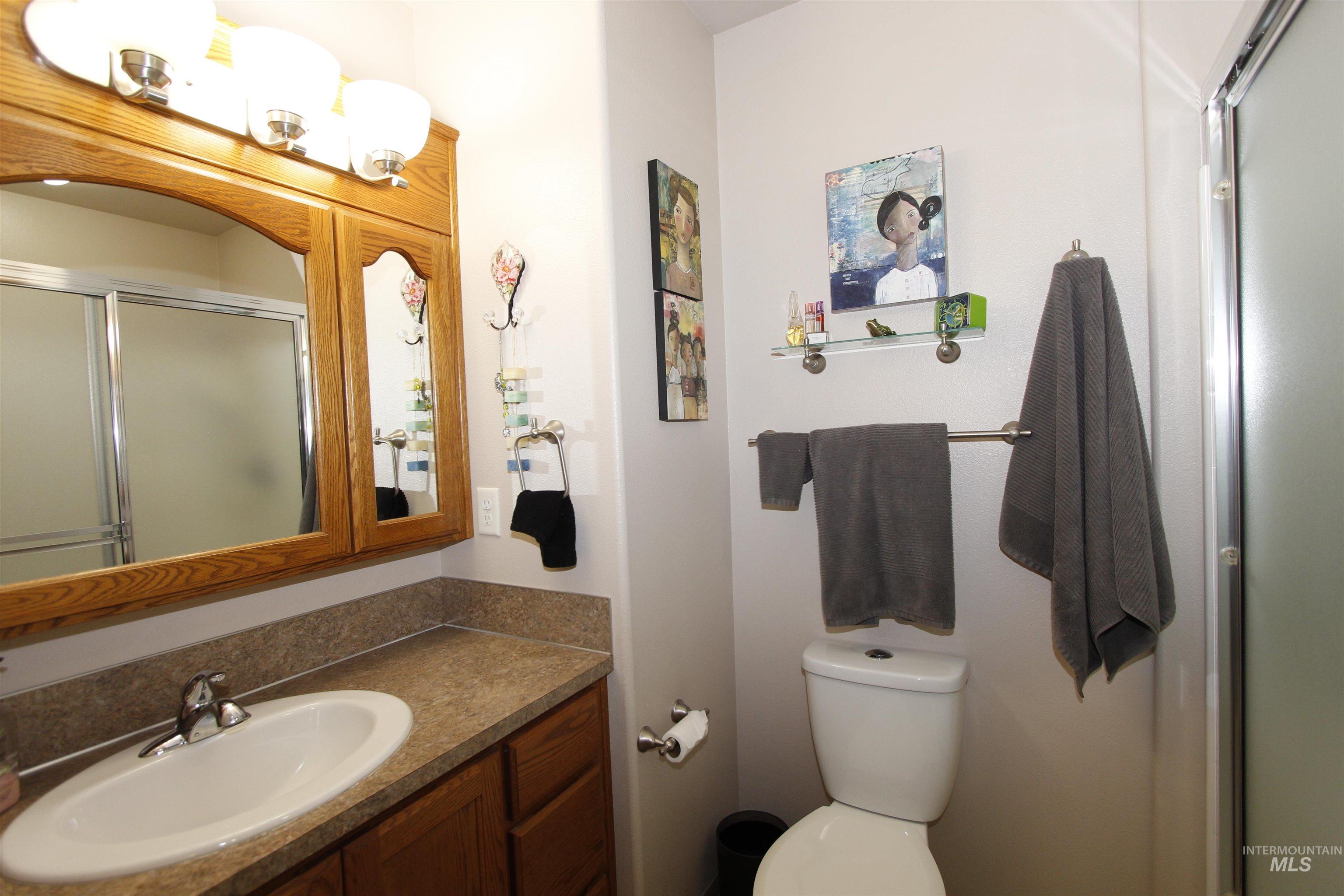 1803 16th Street Lewiston, ID 83501 - Photo 15 of 22 Bathroom featuring an oak-finish vanity with a laminate countertop and integrated sink