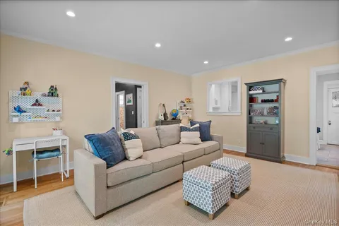 a living room with furniture a table and a floor to ceiling window