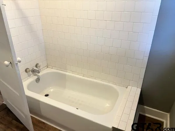 a white bath tub sitting in a bathroom