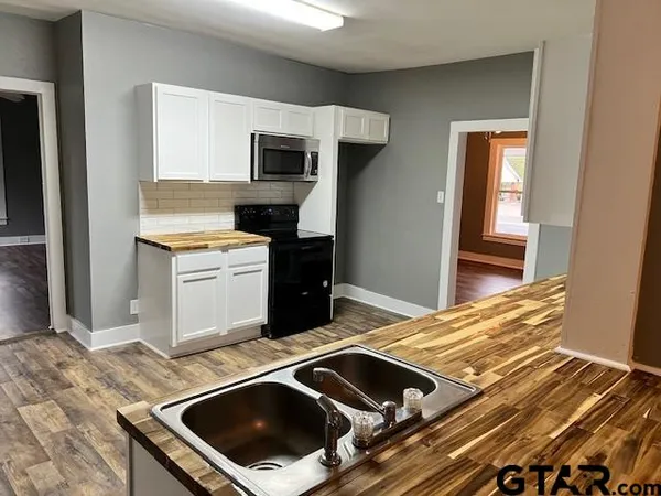 a kitchen with a stove and a microwave