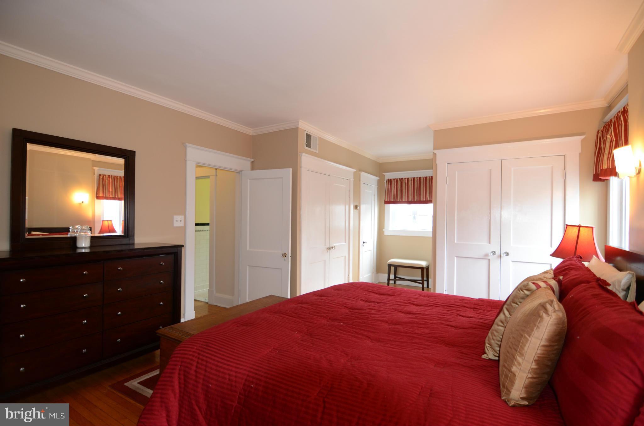 4425 Wickford Road Baltimore, MD 21210 - Photo 13 of 28 a bedroom with a bed and a closet with mirror