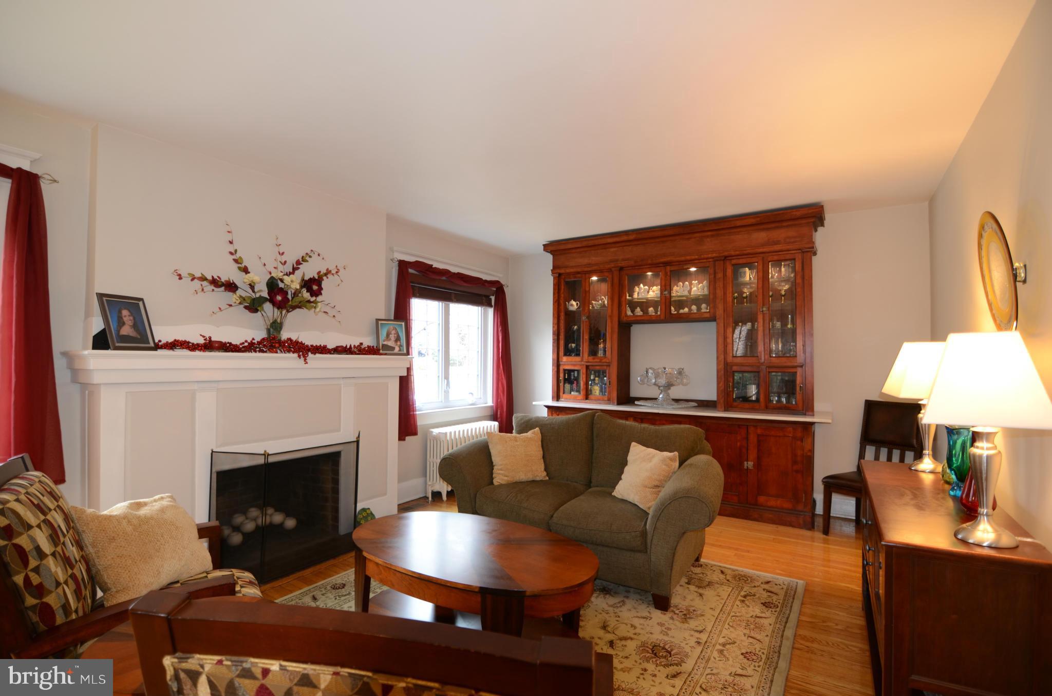 4425 Wickford Road Baltimore, MD 21210 - Photo 3 of 28 a living room with furniture a large window and a fireplace