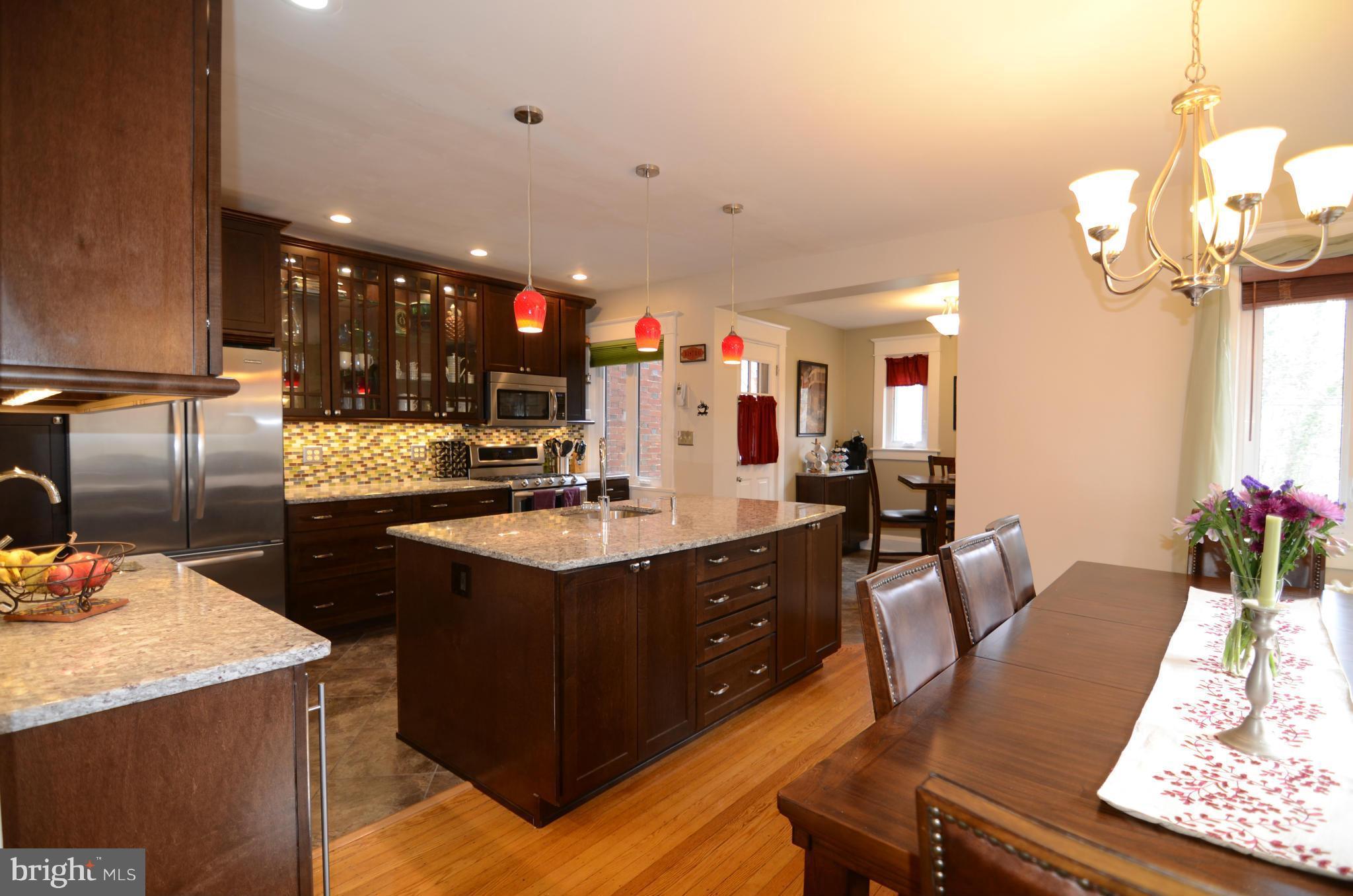 4425 Wickford Road Baltimore, MD 21210 - Photo 6 of 28 a kitchen with a table chairs and white cabinets