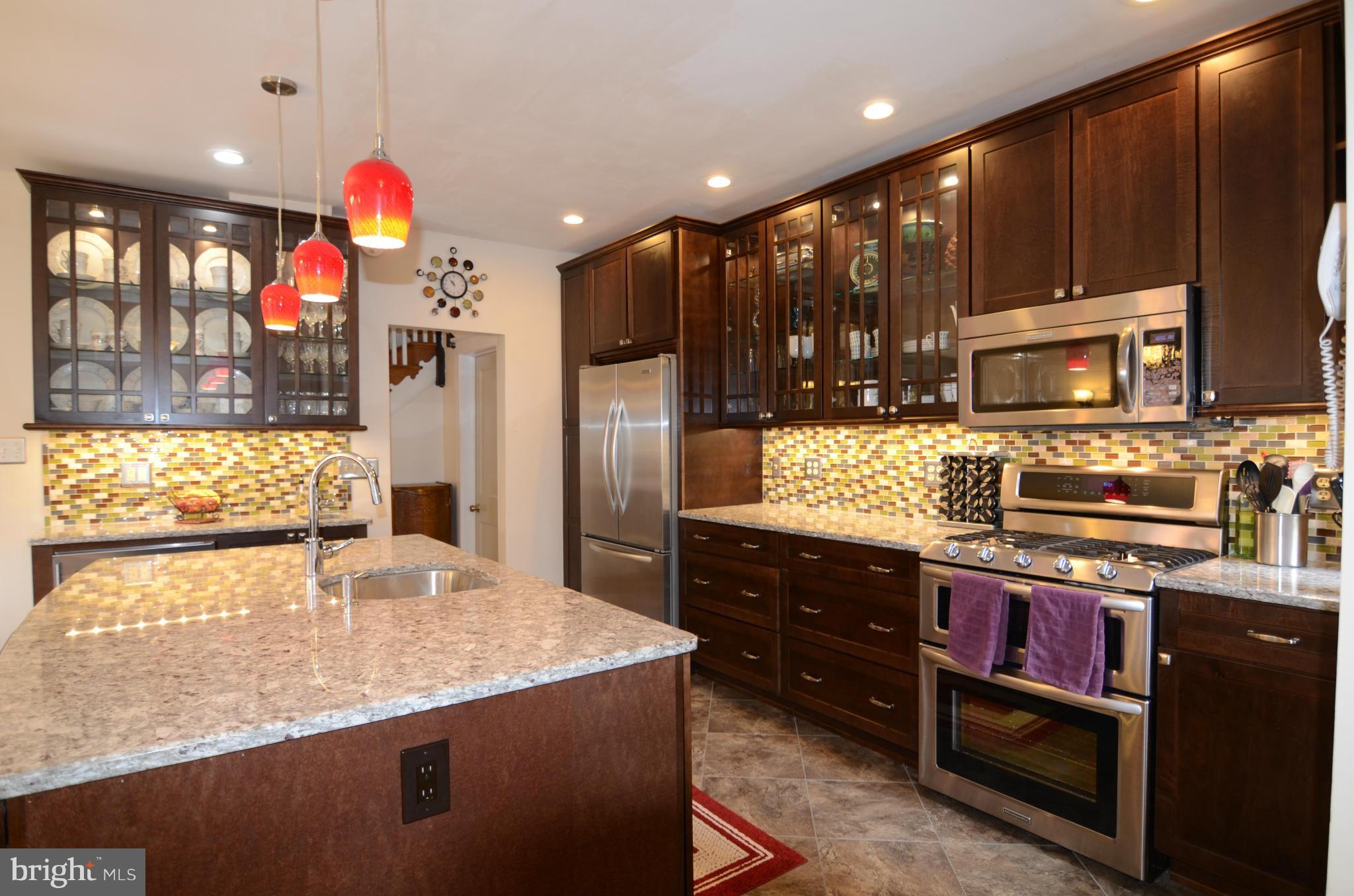 4425 Wickford Road Baltimore, MD 21210 - Photo 8 of 28 a kitchen with stainless steel appliances granite countertop a sink counter space and cabinets