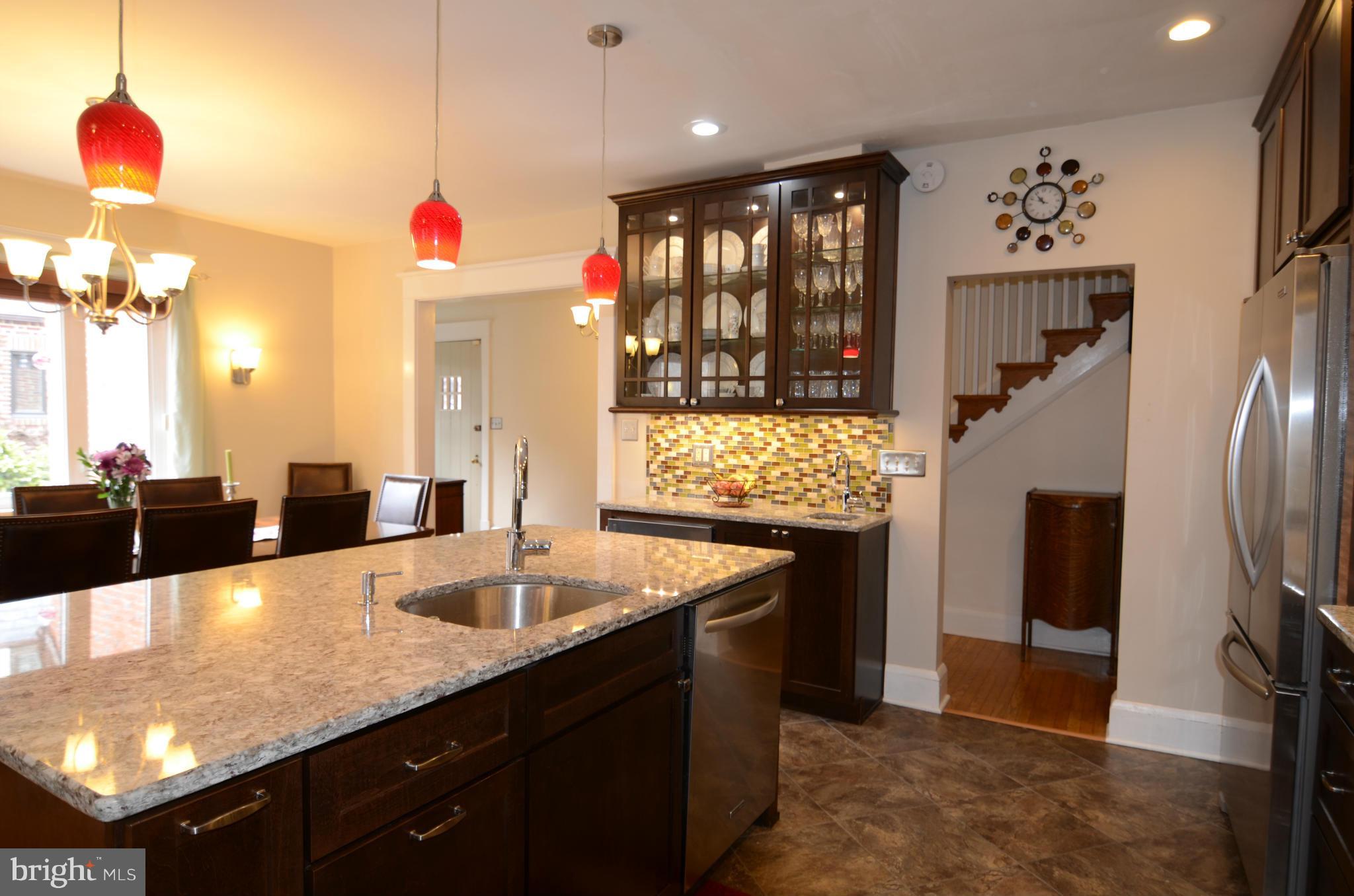 4425 Wickford Road Baltimore, MD 21210 - Photo 9 of 28 a kitchen with granite countertop a sink dishwasher and a refrigerator with wooden floor