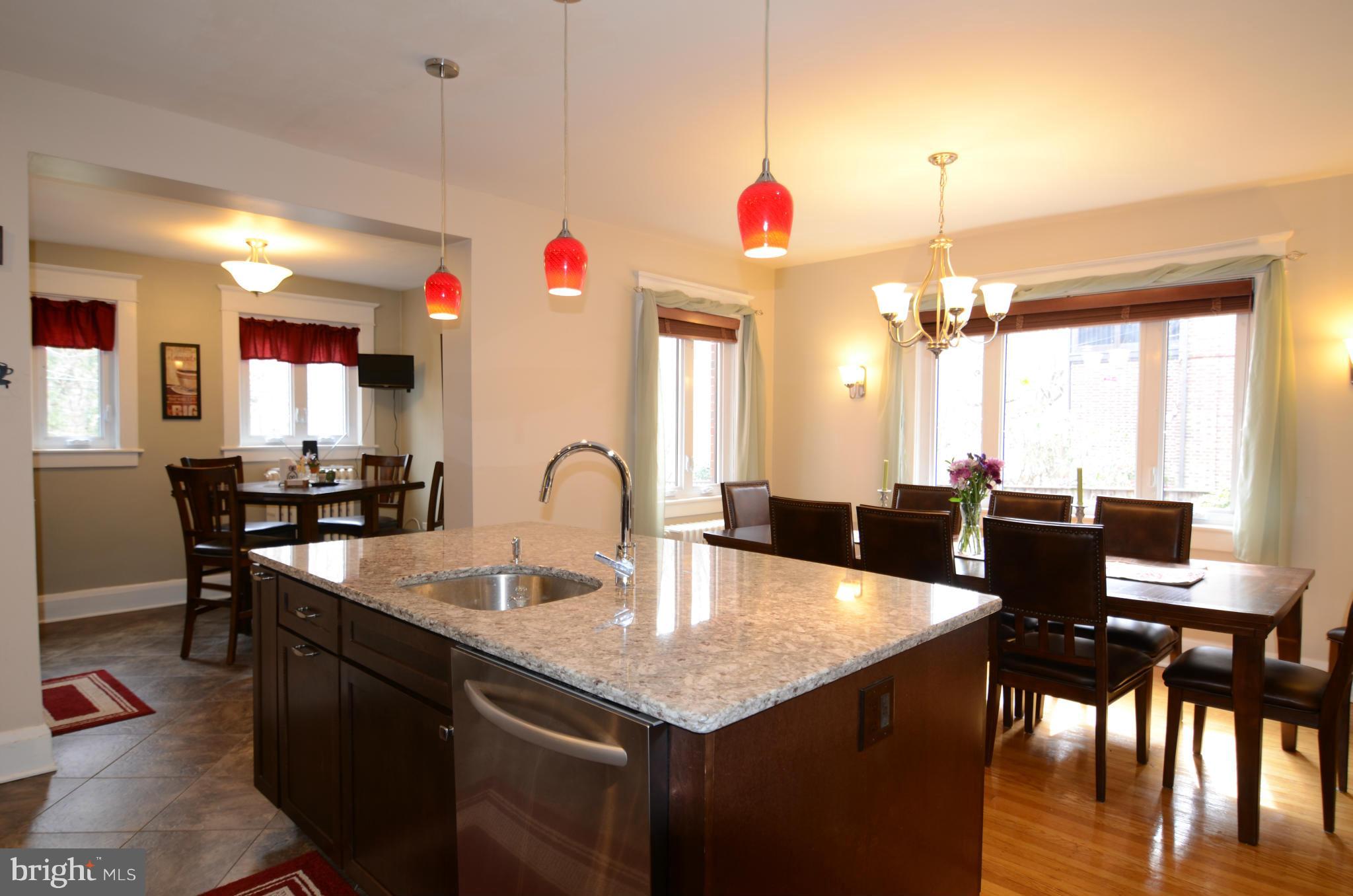 4425 Wickford Road Baltimore, MD 21210 - Photo 10 of 28 a kitchen with a dining table chairs sink and granite counter tops