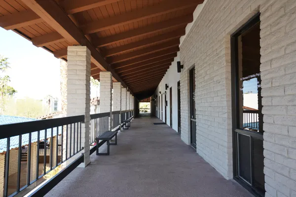 a view of hallway with stairs and furniture