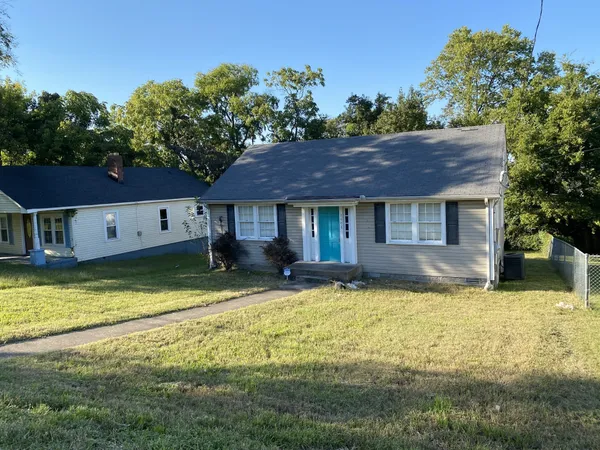 a view of a house with swimming pool next to a yard