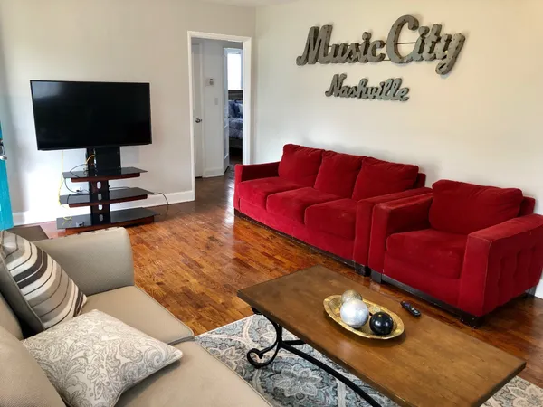 a living room with furniture and a flat screen tv