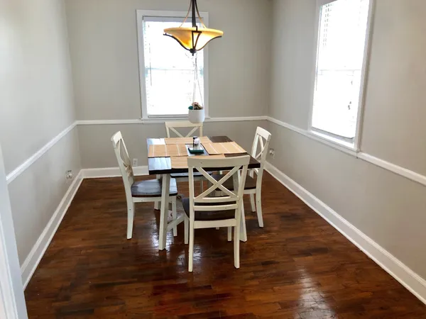 a view of a dining room with furniture and wooden floor